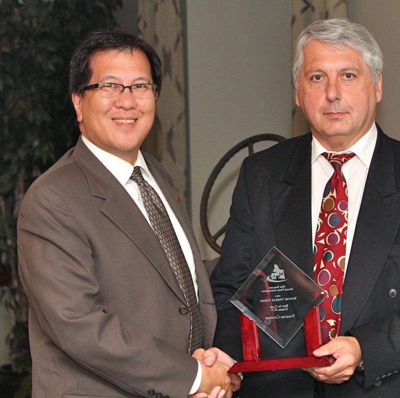 Gary Fong, Porsche Cars North America, accepts the award for BEST IN CLASS—HYBRID SPORT UTILITY VEHICLE for the Porsche Cayenne from NEMPA V-P John Paul. The Cayenne has proven itself as both a true Porsche and a sales success. This second-generation 2012 Cayenne is roomier than the original and more than 100 pounds lighter, and Porsche is defying convention again by offering one Cayenne model as its first production hybrid. The Cayenne S Hybrid uses a supercharged V-6 and two electric motors to provide propulsion and active all-wheel drive. It's a way to get Porsche quality and luxury with plenty of space for occupants and cargo without sacrificing performance. The hybrid Cayenne sprints to 60 MPH in 6.1 seconds and can reach 150 MPH, yet it can travel 24 highway miles per gallon. That's having your cake and eating it, too.