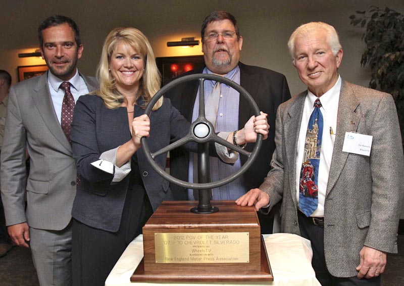 WheelsTV principal Jim Barisano, right, presents his company’s POVOTY (Personally Owned Vehicle of the Year) Award to Pierre Kanter (far left) and Laura Toole, both representing General Motors, on behalf of the 2007-2010 Chevrolet Silverado. Keith Griffin, NEMPA President, blesses the event. The trophy is a wheel from a 1937 Chevy pickup