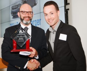 FCA's Ben Lyons accepts the award for the Dodge Charger from NEMPA President, Craig Fitzgerald.