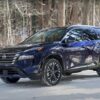 Nissan Rogue’s Great Looks Lend Themselves Well to Video Reviews and Photography, but NEMPA’s Test Team Discovers That There Is a Lot of Substance Under the Gorgeous Exterior Dark blue 2025 Nissan Rogue SUV parked on snowy forest road, winter tires gripping snow-covered ground amid bare trees